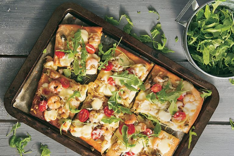 Pizza with shrimps and fresh arugula